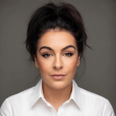 Office Manager Samantha Binford In Front Of Grey Background